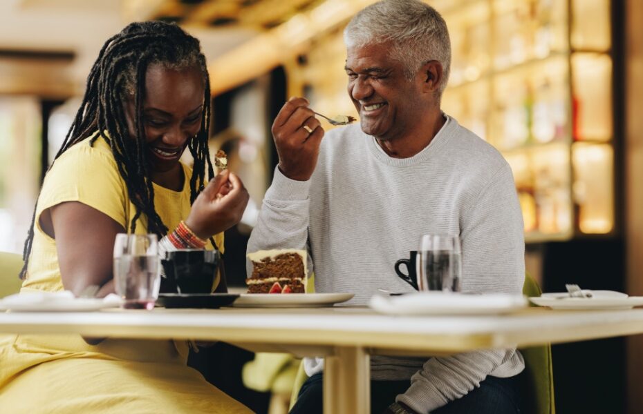 A couple laughing together at a café.
