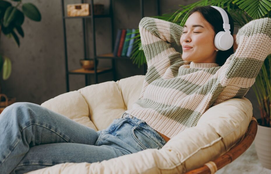 A woman relaxing with headphones on.