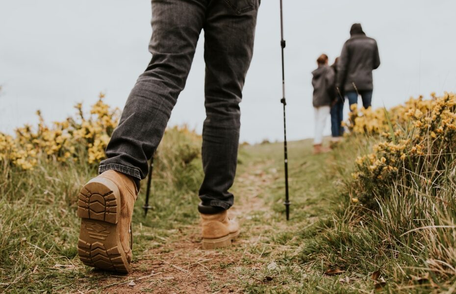 A group of people walking along a hiking trail.