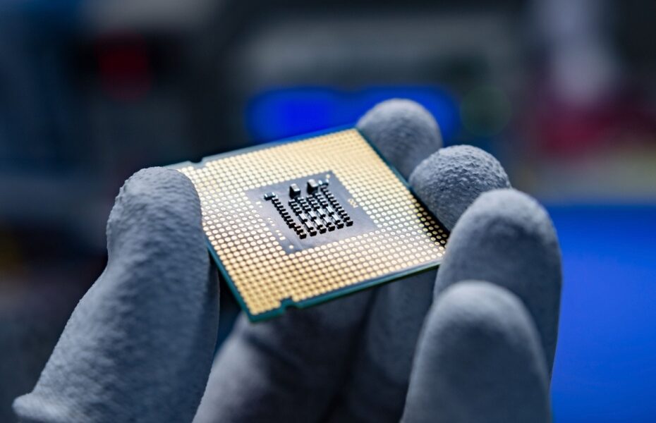 A hand holding a CPU.