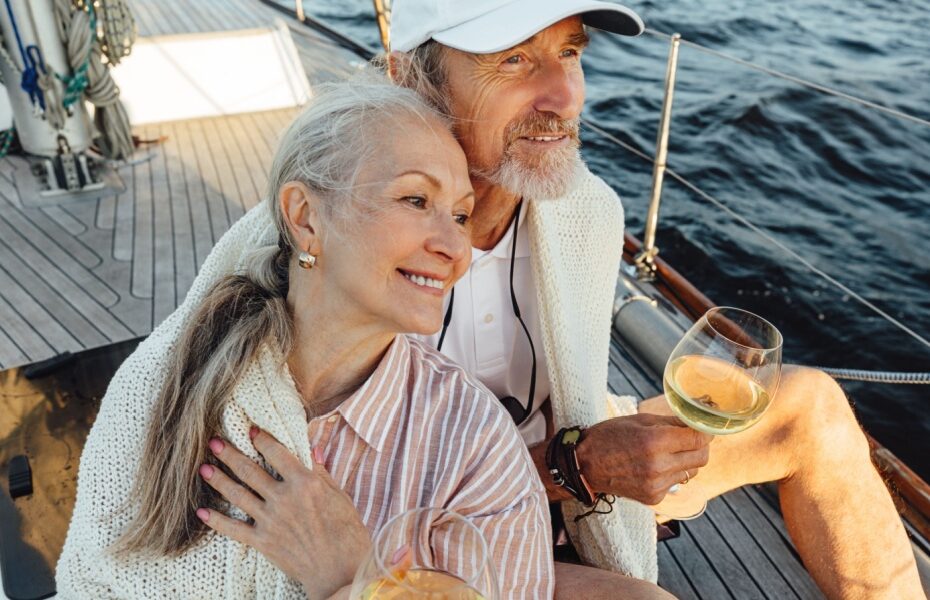 A couple sitting on a yacht deck.
