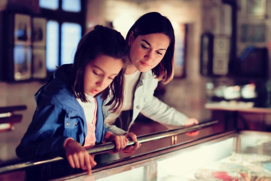 A mother and daughter viewing a museum exhibit.
