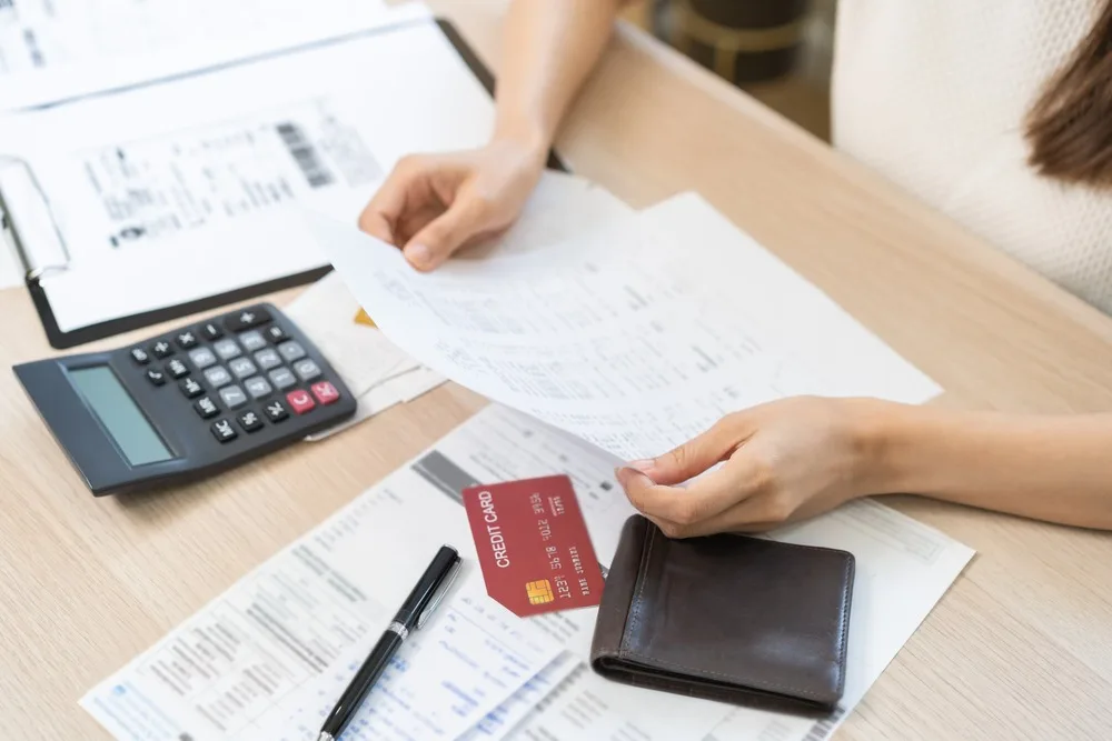 A woman looking at a bank statement.