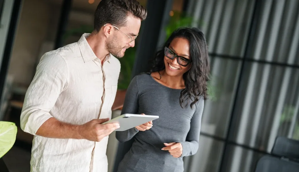 Two employees chatting together.
