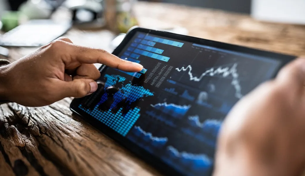 A person reviewing investment performance on a tablet.
